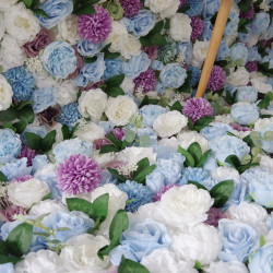 blue and white roses purple lasagna daisies and green leaves cloth roll up flower wall fabric hanging curtain plant wall event party wedding backdrop