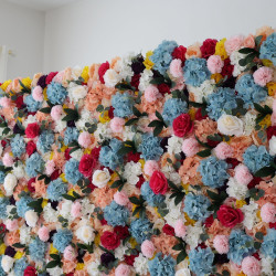 mixed colors of roses and hydrangeas and pink lasagna flowers and green leaves cloth roll up flower wall fabric hanging curtain plant wall event party wedding backdrop