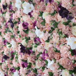 pink and light green roses and pink hydrangeas and purple peonies and green leaves cloth roll up flower wall fabric hanging curtain plant wall event party wedding backdrop